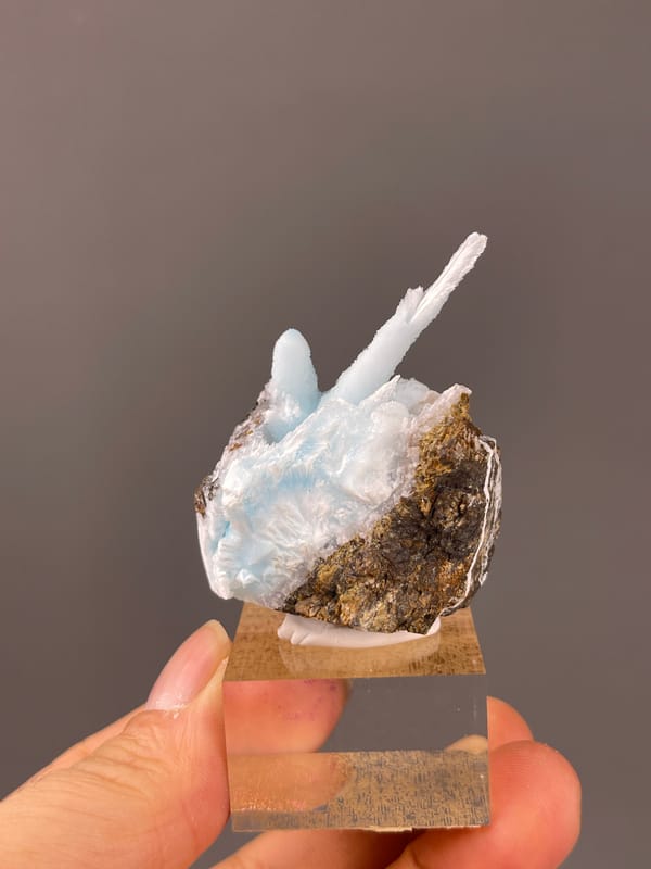 Blue Aragonite specimen from Yunnan, China presenting pale blue columns on matrix