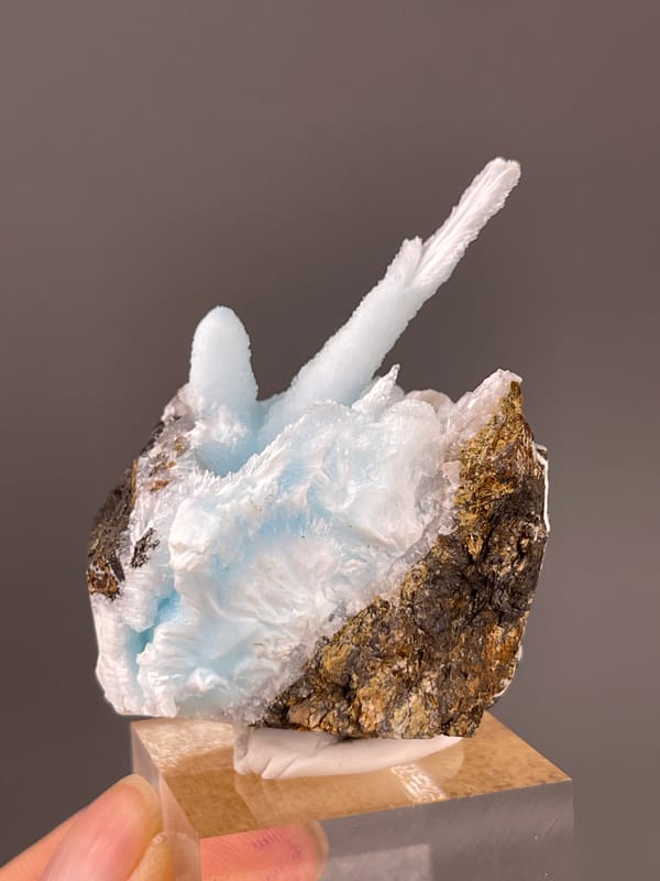Blue Aragonite specimen from Yunnan, China displaying pale blue columns on matrix