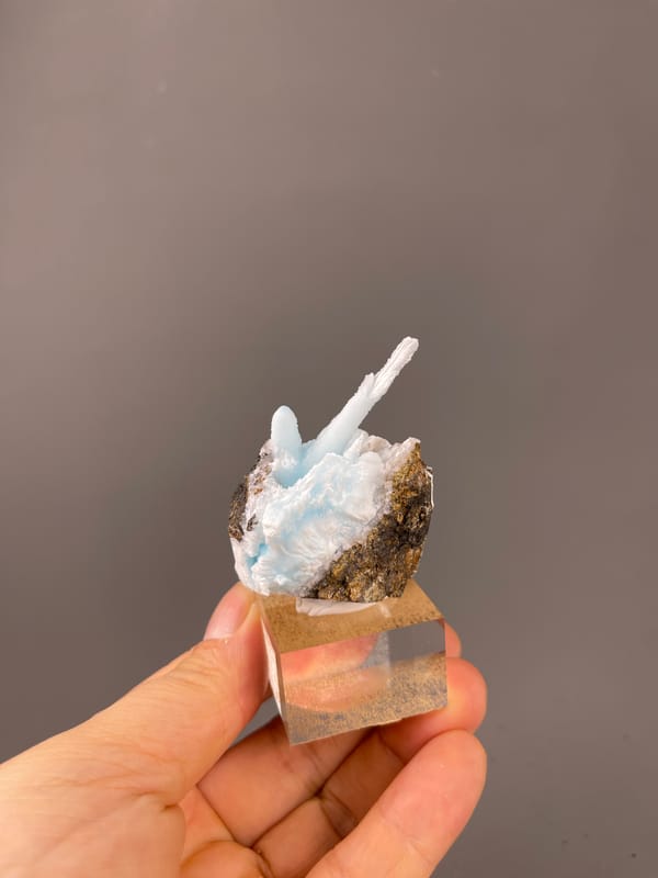 Blue Aragonite specimen from Yunnan, China highlighting pale blue columns on matrix