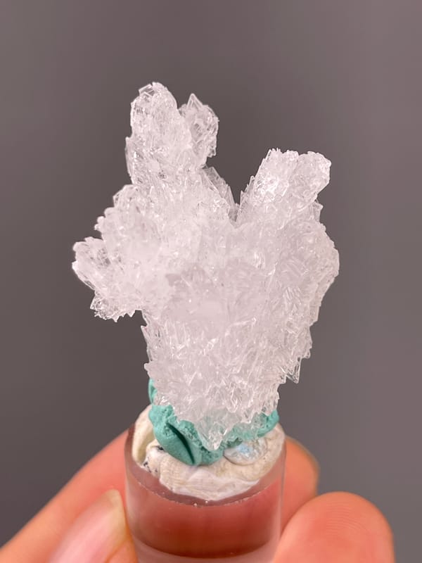 Creedite specimen from Qinglong, Guizhou, China bearing colorless radiating prismatic cluster