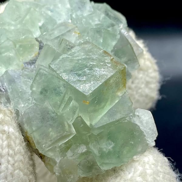 Pale green fluorite cubes with dark sulfide base from Hunan, China, view 7 of 9