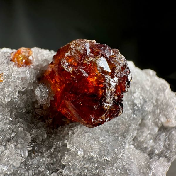 Single dark red sphalerite crystal on grey quartz druse from Hunan, China, view 4 of 13