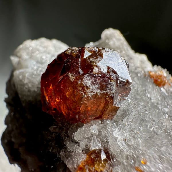 Single dark red sphalerite crystal on grey quartz druse from Hunan, China, view 6 of 13