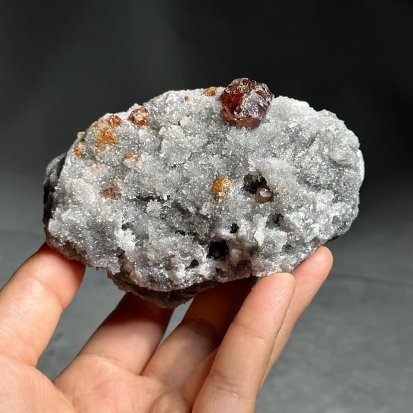 Single dark red sphalerite crystal on grey quartz druse from Hunan, China, view 8 of 13