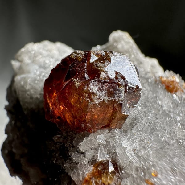 Single dark red sphalerite crystal on grey quartz druse from Hunan, China, view 13 of 13