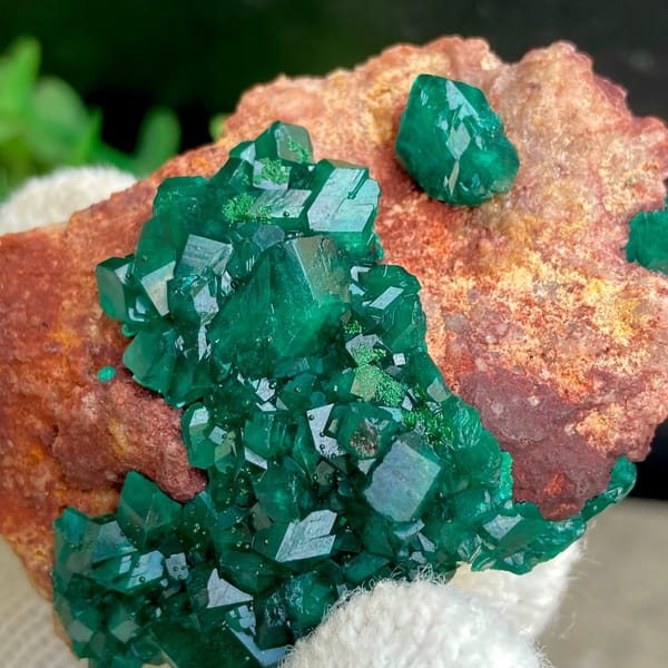 Emerald-green dioptase crystals on orange-brown matrix from Africa, view 4 of 9