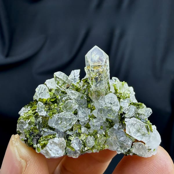 Clear quartz spire above green epidote cluster from Sichuan, China