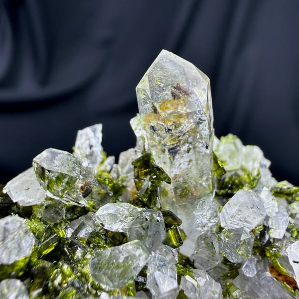 Clear quartz spire above green epidote cluster from Sichuan, China, view 2 of 6