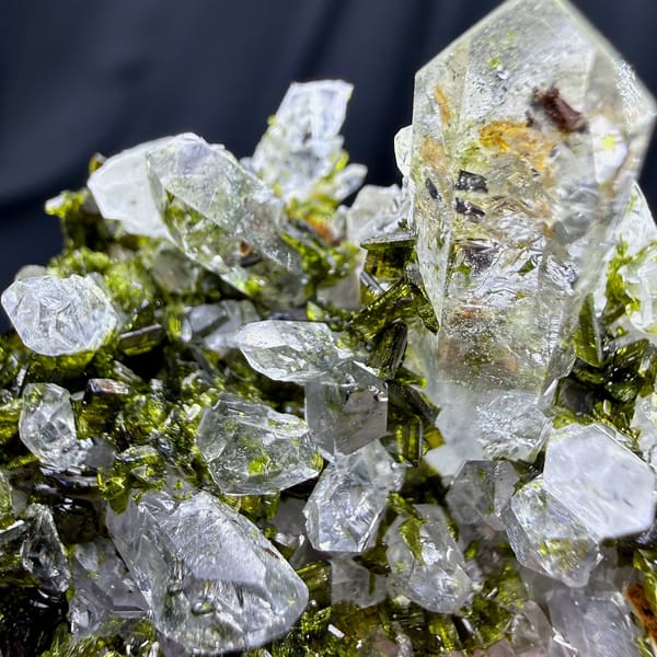 Clear quartz spire above green epidote cluster from Sichuan, China, view 3 of 6