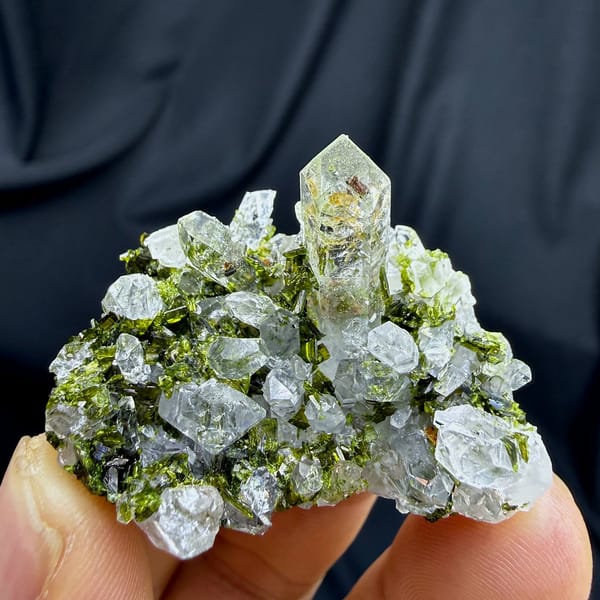 Clear quartz spire above green epidote cluster from Sichuan, China, view 4 of 6