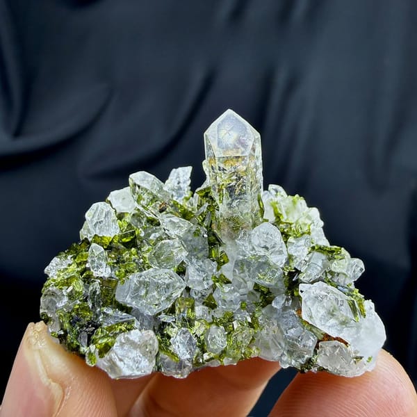 Clear quartz spire above green epidote cluster from Sichuan, China, view 6 of 6