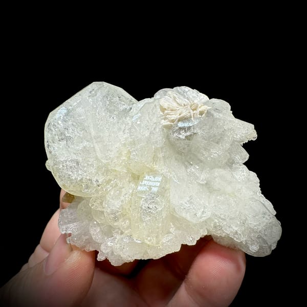 Etched hollowed aquamarine crystal with mica and scheelite from Xuebaoding, Sichuan, China, close-up of the crystal faces