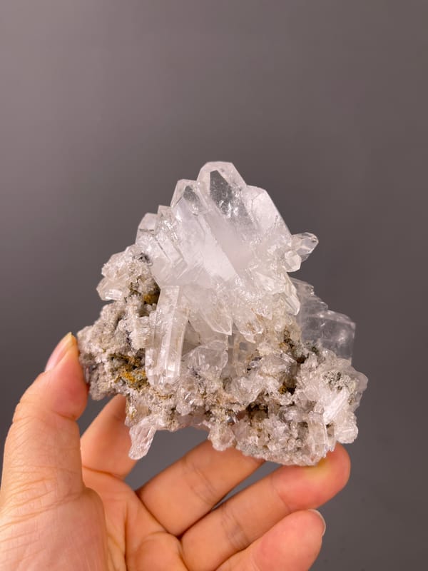 Clear milky quartz cluster visible on faden quartz specimen from Pakistan