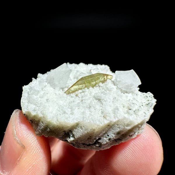 Single olive titanite blade on white feldspar druse from Pakistan