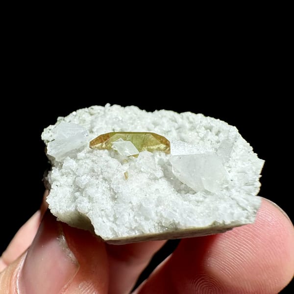 Single olive titanite blade on white feldspar druse from Pakistan, view 3 of 6