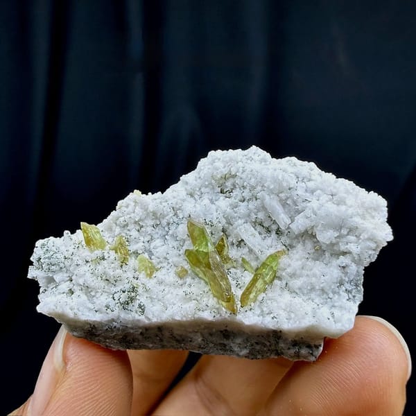 Yellow-green titanite blades on white feldspar plate from Pakistan