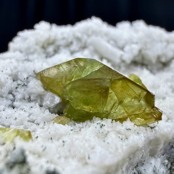 Yellow-green titanite blades on white feldspar plate from Pakistan, view 3 of 6
