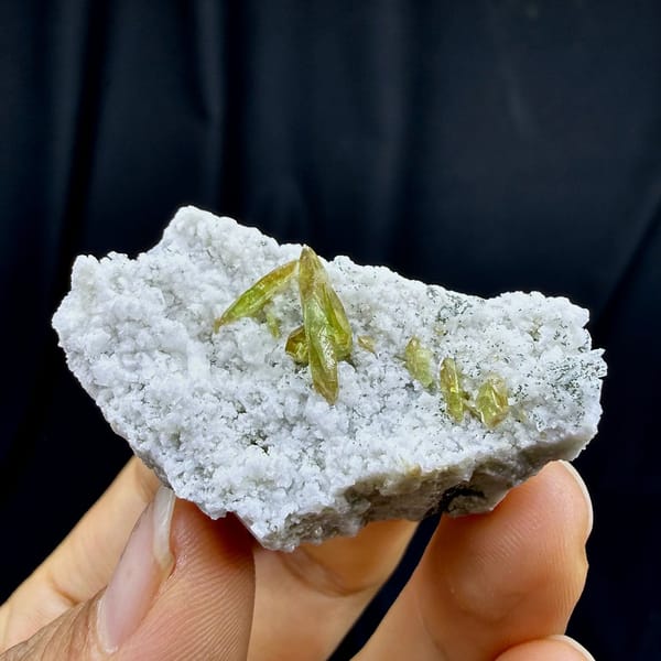 Yellow-green titanite blades on white feldspar plate from Pakistan, view 5 of 6