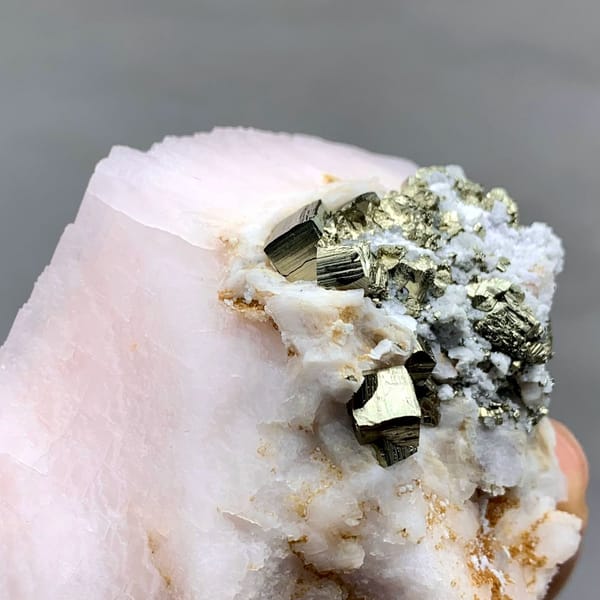 Pale pink kutnohorite with brassy pyrite cluster from Peru, view 3 of 6