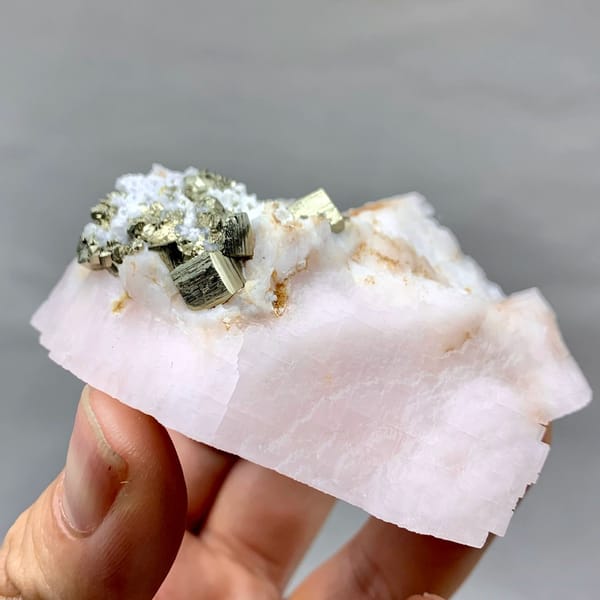 Pale pink kutnohorite with brassy pyrite cluster from Peru, view 5 of 6