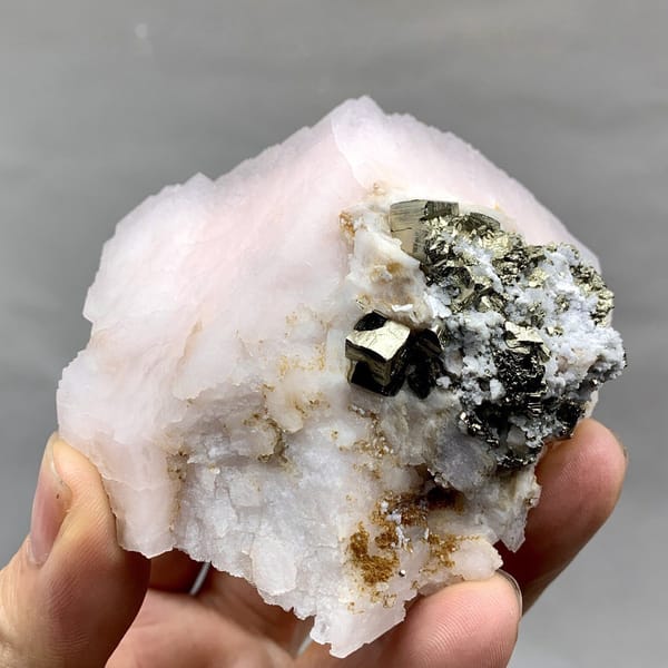 Pale pink kutnohorite with brassy pyrite cluster from Peru, view 6 of 6