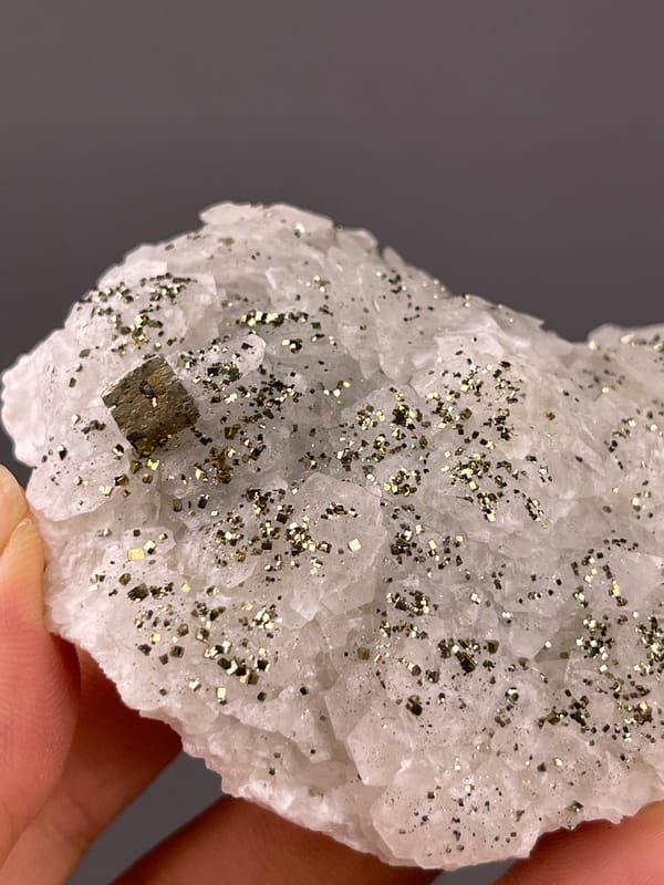 Fluorescent Petal-form Calcite specimen from Longyan, Fujian, China showing white petal-form druse with pyrite