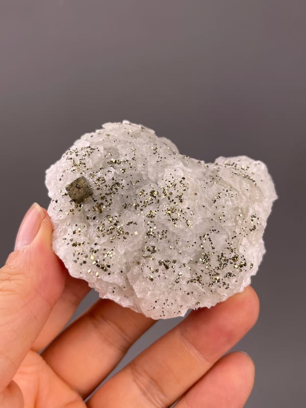 Fluorescent Petal-form Calcite specimen from Longyan, Fujian, China presenting white petal-form druse with pyrite