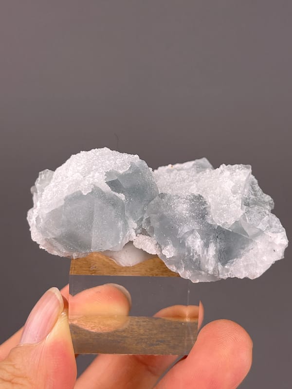 Fluorite from Fujian, China: angled blue-gray crystal face under white druse.