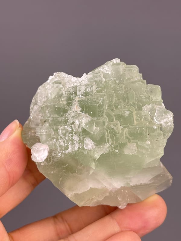 Fluorite from Fujian, China: broad green face above a pale base.
