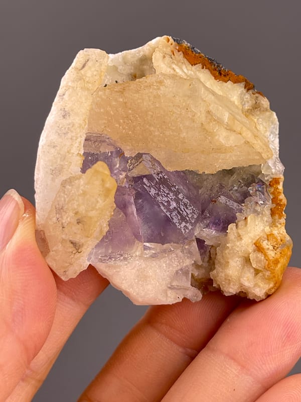 Fluorite from Fujian, China: upright profile with pale calcite above purple faces.