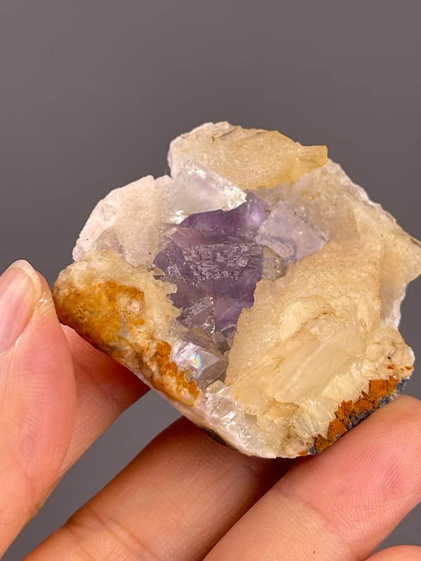 Fluorite from Fujian, China: purple crystal face seen through a pale opening.
