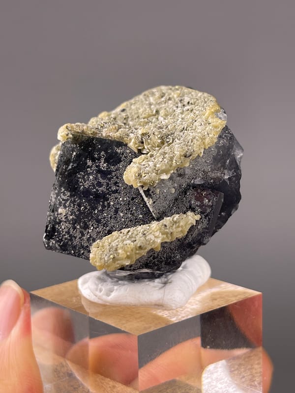 Fluorite from Fujian, China: close angle on the coated upper crystal edge.