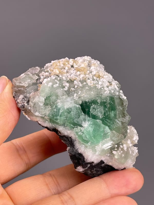 Fluorite from Fujian, China: upper surface with small white crystalline patches.