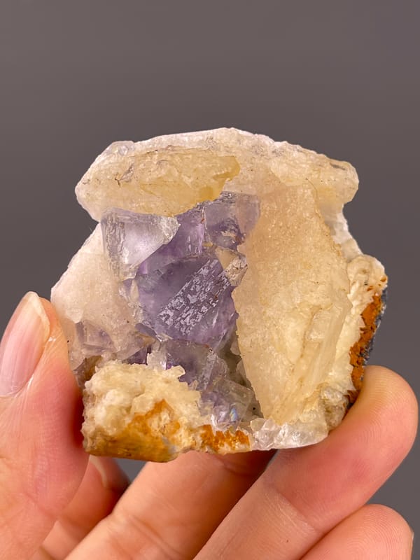 Fluorite from Fujian, China: side view of violet faces and pale calcite.