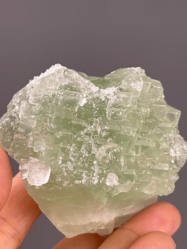 Fluorite from Fujian, China: close frontal view of textured green faces.
