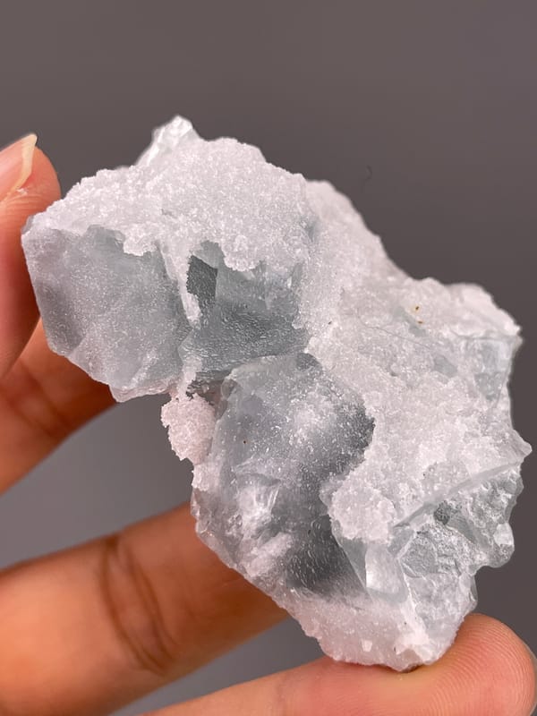 Fluorite from Fujian, China: front face showing uneven white quartz coverage.