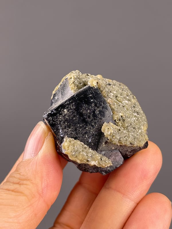 Fluorite from Fujian, China: diagonal view across dark faces and pale margins.