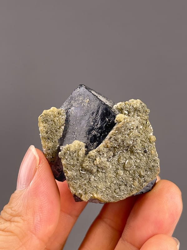 Fluorite from Fujian, China: back corner with pale coating and exposed dark faces.