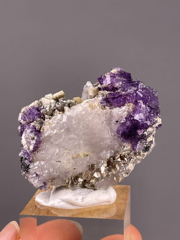Fluorite from Yaogangxian, Hunan, China: broad pale center framed by purple crystal faces.
