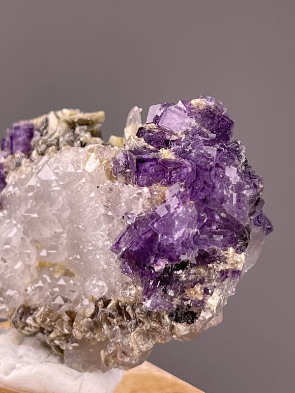 Fluorite from Yaogangxian, Hunan, China: close view of purple faces and silvery mica.