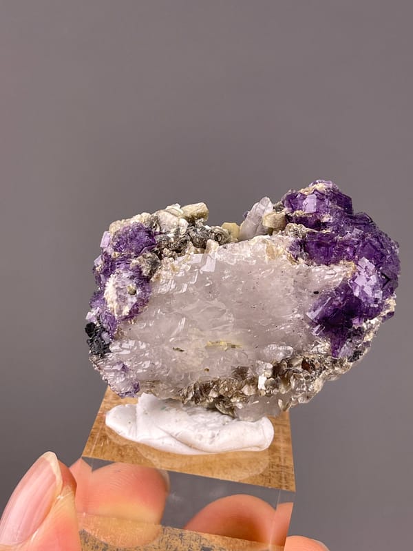 Fluorite from Yaogangxian, Hunan, China: front view with violet crystals at the upper edge.