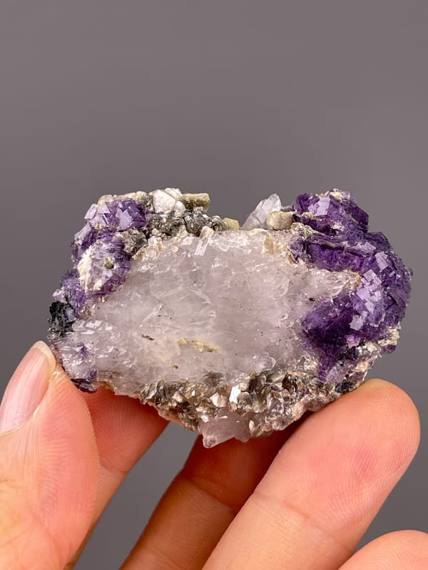 Fluorite from Yaogangxian, Hunan, China: whole quartz-rich face framed by purple crystals.