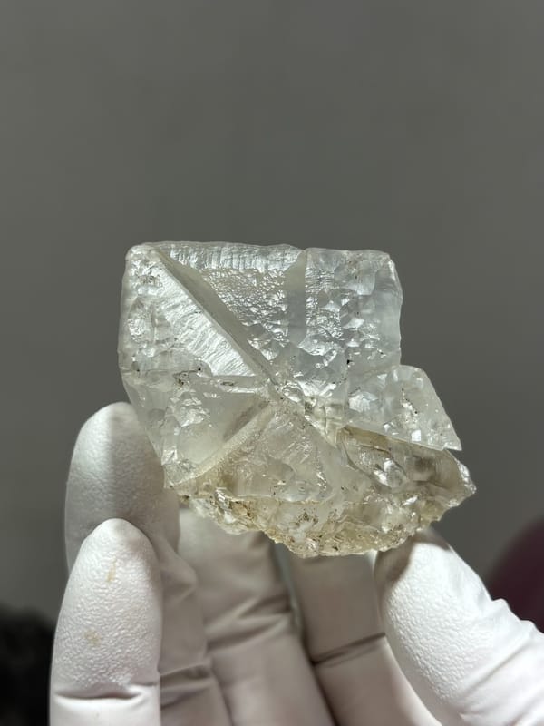 Frosted white fluorite cube from Xuebaoding, Sichuan, China, detail of the matrix contact