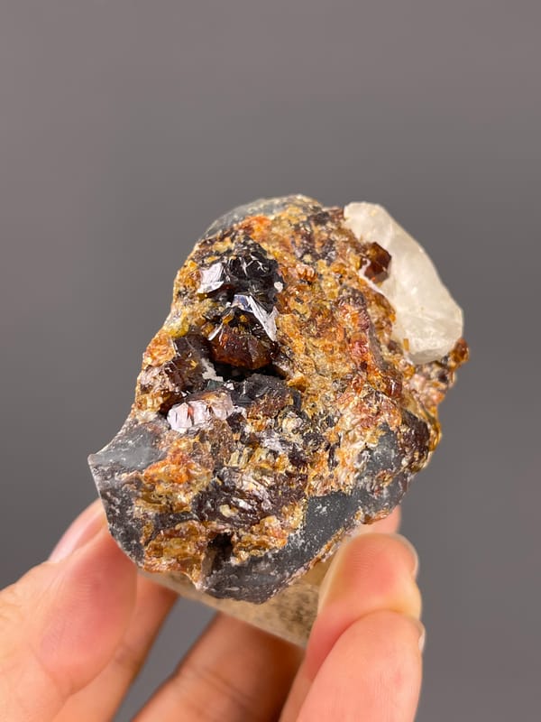 Garnet from Yunxiao, Fujian, China: upright edge showing brown crystals and white calcite.