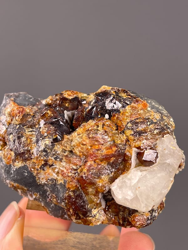 Garnet from Yunxiao, Fujian, China: brown faceted crystals next to pale calcite.