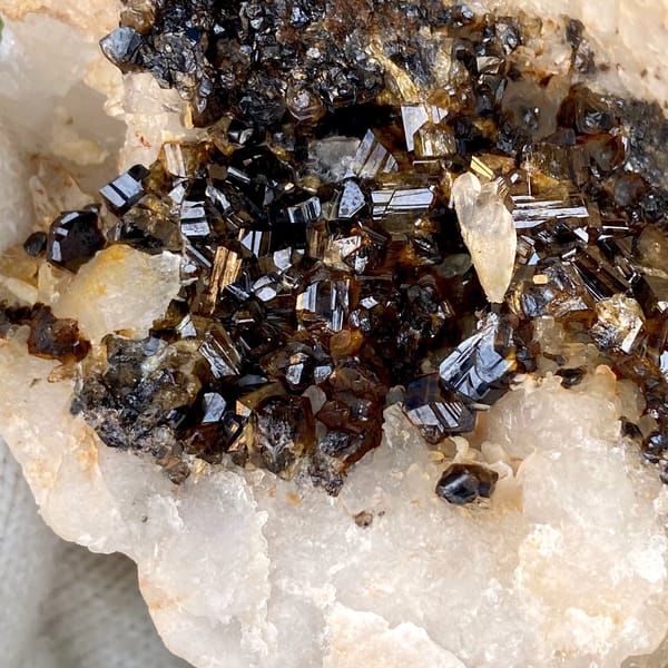 Plate of gemmy brown cassiterite on white quartz from Yunnan, China, view 3 of 9