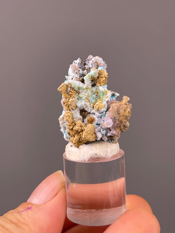 Gibbsite specimen from Qinglong, Guizhou, China featuring blue-pink botryoidal material with yellow matrix