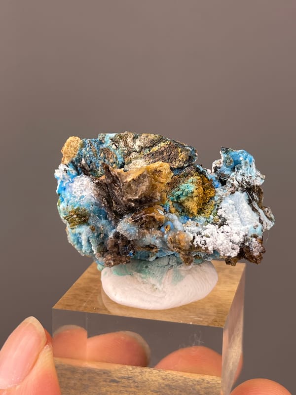 Gibbsite specimen from Qinglong, Guizhou, China featuring pale blue fibrous material with white druse