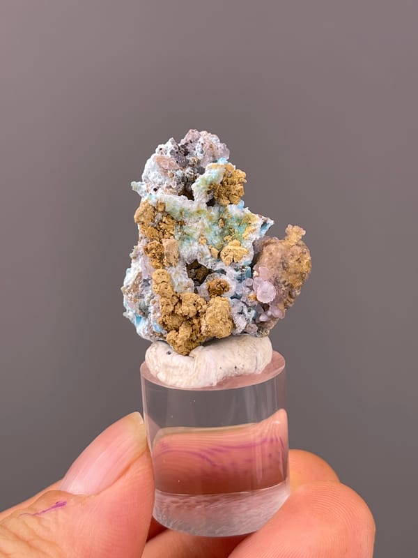 Gibbsite specimen from Qinglong, Guizhou, China showing blue-pink botryoidal material with yellow matrix