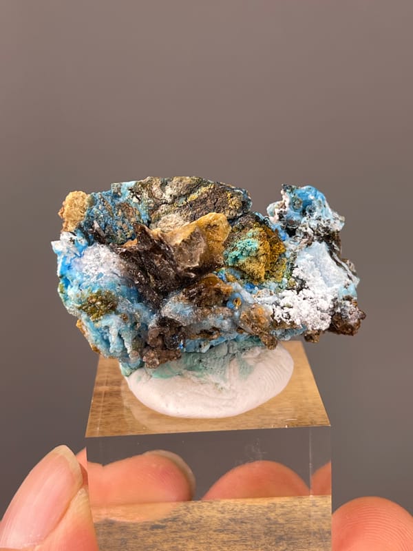 Gibbsite specimen from Qinglong, Guizhou, China showing pale blue fibrous material with white druse